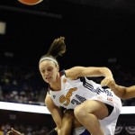 Connecticut Sun's Kelly Faris, top tables with Phoenix Mercury's Alexis Hornbuckle, bottom, during the first half of a WNBA basketball game in Uncasville, Conn., Saturday, June 29, 2013. (AP Photo/Jessica Hill)
