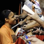 West player Maya Moore, of the Minnesota Lynx, signs autographs before the WNBA All-Star basketball game in Uncasville, Conn., Saturday, July 27, 2013. (AP Photo/Jessica Hill)

