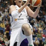 Minnesota Lynx forward Janel McCarville (4) goes up to the basket past Phoenix Mercury forward Charde Houston during the first half of a WNBA basketball game, Thursday, June 6, 2013, in Minneapolis. (AP Photo/Stacy Bengs)