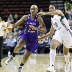 Phoenix Mercury's Charde Houston, left, tries to drive pas Seattle Storm's Tanisha Wright in the first half of a WNBA basketball game Thursday, Aug. 1, 2013, in Seattle. The Storm won 88-79. (AP Photo/Elaine Thompson)