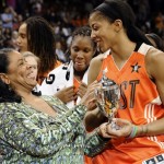 West's Candace Parker, right, of the Los Angeles Sparks, receives the MVP trophy from WNBA President Laurel Richie after the WNBA All-Star basketball game in Uncasville, Conn., Saturday, July 27, 2013. The West won 102-98. (AP Photo/Jessica Hill)
