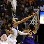 Phoenix Mercury's Brittney Griner, middle, blocks the shot of Los Angeles Sparks' Marissa Coleman, right, as the Mercury's Briana Gilbreath (15) looks on during the second half in a WNBA basketball game on Friday, June 14, 2013, in Phoenix. The Mercury defeated the Sparks 97-81. (AP Photo/Ross D. Franklin)
