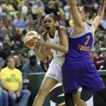 Seattle Storm's Tina Thompson, left, tries to drive past Phoenix Mercury's Diana Taurasi in the first half of a WNBA basketball game, Sunday, June 2, 2013, in Seattle. (AP Photo/Elaine Thompson)