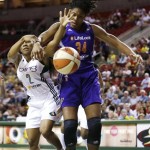 Seattle Storm's Temeka Johnson (2) and Phoenix Mercury's Krystal Thomas fight for a loose ball in the first half of a WNBA basketball game on Thursday, Aug. 1, 2013, in Seattle. (AP Photo/Elaine Thompson)