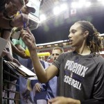 Phoenix Mercury's Brittney Griner stops to sign autographs for fans before a WNBA basketball game against the Seattle Storm Sunday, June 2, 2013, in Seattle. (AP Photo/Elaine Thompson)