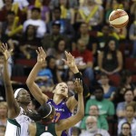 Seattle Storm's Nakia Sanford, left, and Noelle Quinn and Phoenix Mercury's Brittney Griner reach for a loose ball in the first half of a WNBA basketball game Sunday, June 2, 2013, in Seattle. (AP Photo/Elaine Thompson)