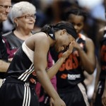 East's Ivory Latta, of the Washington Mystics, laughs after receiving a check-up from a trainer after being fouled in the during the first half of the WNBA All-Star basketball game in Uncasville, Conn., Saturday, July 27, 2013. (AP Photo/Jessica Hill)
