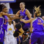 Phoenix Mercury's DeWanna Bonner (24) celebrating with Diana Taurasi and Penny Taylor (13) as the team wins the WNBA championship with an 87-82 win over the Chicago Sky in Game 3 of the WNBA Finals basketball series, Friday, Sept. 12, 2014, in Chicago. (AP Photo/Kamil Krzaczynski)