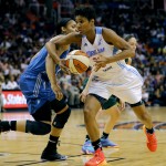East's Angel McCoughtry, right, of the Atlanta Dream, drives past West's Maya Moore, of the Minnesota Lynx, during the second half the WNBA All-Star basketball game, Saturday, July 19, 2014, in Phoenix. The East won 125-124 in overtime. (AP Photo/Matt York)