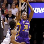 West's Nneka Ogwumike (30), of the Los Angeles Sparks, rebounds over East's Tamika Catchings (24), of the Indiana Fever, during the first half the WNBA All-Star basketball game, Saturday, July 19, 2014, in Phoenix. (AP Photo/Matt York)
