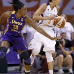 Phoenix Mercury's Diana Taurasi (3) spins away from Los Angeles Sparks' Nneka Ogwumike (30) who reaches out in vain to steal the ball during the first half in Game 1 of the WNBA basketball Western Conference semifinals Friday, Aug. 22, 2014, in Phoenix. (AP Photo/Ross D. Franklin)
