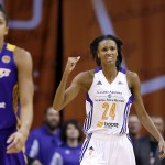 Phoenix Mercury's DeWanna Bonner (24) pumps her fist as Los Angeles Sparks' Candace Parker (3) walks down the court after a turnover during the second half in Game 1 of the WNBA basketball Western Conference semifinals Friday, Aug. 22, 2014, in Phoenix. The Mercury defeated the Sparks 75-72. (AP Photo/Ross D. Franklin)