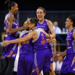 Phoenix Mercury players celebrate as the team wins the WNBA championship with an 87-82 win over Chicago Sky in Game 3 of the WNBA Finals basketball series, Friday, Sept. 12, 2014, in Chicago. From left are DeWanna Bonner, Penny Taylor, Diana Taurasi, Ewelina Kobryn, rear, and Candice Dupree. (AP Photo/Kamil Krzaczynski)
