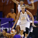 Phoenix Mercury's Penny Taylor (13) dribbles with the ball after Los Angeles Sparks' Candace Parker, left, lost the ball, while Mercury's Brittney Griner, top, tries to avoid Parker on the floor during the second half in Game 1 of the WNBA basketball Western Conference semifinals Friday, Aug. 22, 2014, in Phoenix. The Mercury defeated the Sparks 75-72. (AP Photo/Ross D. Franklin)