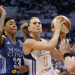 Phoenix Mercury's Penny Taylor (13), of Australia, drives past Minnesota Lynx's Seimone Augustus (33) during the second half in Game 1 of the WNBA basketball Western Conference finals Friday, Aug. 29, 2014, in Phoenix. The Mercury defeated the Lynx 85-71. (AP Photo/Ross D. Franklin)