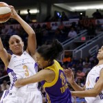 Phoenix Mercury's Diana Taurasi (3) grabs a rebound in front of Los Angeles Sparks' Kristi Toliver (20) as Mercury's Candice Dupree (4) looks on during the first half in Game 1 of the WNBA basketball Western Conference semifinals Friday, Aug. 22, 2014, in Phoenix. (AP Photo/Ross D. Franklin)