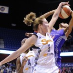 Connecticut Sun's Kelsey Griffin (5) blocks the shot of Phoenix Mercury's DeWanna Bonner (24) as Connecticut Sun's Danielle McCray (4) looks on during the first half of their WNBA basketball game in Uncasville, Conn., Thursday, June 12, 2014. (AP Photo/Fred Beckham)