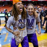 Phoenix Mercury's Brittney Griner, left, holds the WNBA championship trophy as she stands with Diana Taurasi after the Mercury defeated the Chicago Sky 87-82 in Game 3 and swept the WNBA Finals basketball series, Friday, Sept. 12, 2014, in Chicago. (AP Photo/Kamil Krzaczynski)