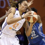  Phoenix Mercury's Brittney Griner (42) gets hit in the face by Minnesota Lynx's Rebekkah Brunson (32) as she goes up for a shot during the first half of Game 3 in the WNBA Western Conference basketball finals Tuesday, Sept. 2, 2014, in Phoenix. (AP Photo/Ross D. Franklin)