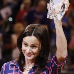 Phoenix Mercury head coach Sandy Brondello, of Australia, raises her WNBA Coach of The Year trophy as she acknowledges a cheering crowd prior to Game 1 of the WNBA basketball Western Conference semifinals against the Los Angeles Sparks, Friday, Aug. 22, 2014, in Phoenix. (AP Photo/Ross D. Franklin)