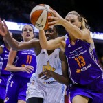 Chicago Sky center Sylvia Fowles, center, reaches for the ball with Phoenix Mercury forward Penny Taylor (13) during the second half of Game 3 of the WNBA Finals basketball series, Friday, Sept. 12, 2014, in Chicago. The Mercury won 87-82. (AP Photo/Kamil Krzaczynski)