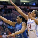 East's Erika de Souza (14), of the Atlanta Dream, defends as West's Maya Moore, of the Minnesota Lynx, drives during the first half the WNBA All-Star basketball game, Saturday, July 19, 2014, in Phoenix. (AP Photo/Matt York)