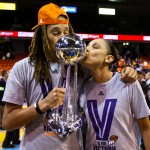 Phoenix Mercury center Brittney Griner, left, and guard Diana Taurasi kiss the WNBA hampionship trophy after the Mercury defeated the Chicago Sky 87-82 and swept the WNBA Finals basketball series, Friday, Sept. 12, 2014, in Chicago. (AP Photo/Kamil Krzaczynski)