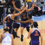 Phoenix Mercury's Diana Taurasi, left, and Penny Taylor celebrate after the Mercury defeated the Chicago Sky 87-82 in Game 3 of the WNBA Finals basketball series to take the WNBA championship, Friday, Sept. 12, 2014, in Chicago. (AP Photo/Matt Marton)