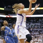 Phoenix Mercury's Penny Taylor, right, of Australia, drives past Minnesota Lynx's Tan White (5) and Rebekkah Brunson (32) during the second half in Game 1 of the WNBA Western Conference finals Friday, Aug. 29, 2014, in Phoenix. The Mercury defeated the Lynx 85-71. (AP Photo/Ross D. Franklin)