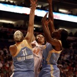 Phoenix Mercury center Brittney Griner (42) shoots over Chicago Sky guard/forward Elena Delle Donne (11) and Sylvia Fowles (34) in the first half of Game 1 of the WNBA basketball finals, Sunday, Sept. 7, 2014, in Phoenix. (AP Photo/Rick Scuteri)