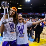 Phoenix Mercury's Brittney Griner, left, holds the WNBA championship trophy as she stands with Diana Taurasi after the Mercury defeated the Chicago Sky 87-82 in Game 3 and swept the WNBA Finals basketball series, Friday, Sept. 12, 2014, in Chicago. (AP Photo/Kamil Krzaczynski)