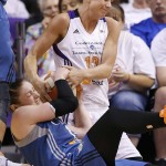 Minnesota Lynx's Lindsay Whalen, bottom, battles Phoenix Mercury's Penny Taylor, of Australia, for a loose ball during the second half in Game 1 of the WNBA Western Conference finals Friday, Aug. 29, 2014, in Phoenix. The Mercury defeated the Lynx 85-71. (AP Photo/Ross D. Franklin)