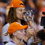 Phoenix Mercury center Brittney Griner kisses the WNBA championship trophy after the Mercury defeated the Chicago Sky 87-82 in Game 3 of the WNBA Finals, Friday, Sept. 12, 2014, in Chicago. (AP Photo/Kamil Krzaczynski)