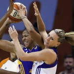 Phoenix Mercury's Penny Taylor, right, turns her head after being elbowed by Los Angeles Sparks' Candace Parker during the second half in Game 1 of the WNBA basketball Western Conference semifinals Friday, Aug. 22, 2014, in Phoenix. The Mercury defeated the Sparks 75-72. (AP Photo/Ross D. Franklin)