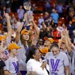 Phoenix Mercury center Brittney Griner holds up the WNBA basketball championship trophy after the Mercury defeated the Chicago Sky 87-82 and swept the WNBA Finals, Friday, Sept. 12, 2014, in Chicago. (AP Photo/Kamil Krzaczynski)