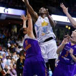 Chicago Sky center Sylvia Fowles shoots between Phoenix Mercury center Ewelina Kobryn (11) and guard Diana Taurasi (3) during the second half of Game 3 of the WNBA Finals basketball series, Friday, Sept. 12, 2014, in Chicago. The Mercury won 87-82 to sweep the series. (AP Photo/Kamil Krzaczynski)