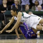 Seattle Storm' Tanisha Wright tumbles to the court in front of Phoenix Mercury's DeWanna Bonner in the first half of a WNBA basketball game on Thursday, Aug. 1, 2013, in Seattle. (AP Photo/Elaine Thompson)