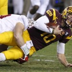 Arizona State's Taylor Kelly (10) gets taken down by Stanford's Trent Murphy during the first half of the NCAA Pac-12 Championship football game Saturday, Dec. 7, 2013, in Tempe, Ariz. (AP Photo/Ross D. Franklin)
