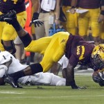 
Sacramento State's Osagie Odiase (1) trips up Arizona State's Marion Grice, right, during the first half in an NCAA college football game on Thursday, Sept. 5, 2013, in Tempe, Ariz. (AP Photo/Ross D. Franklin)