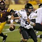 Colorado's Connor Wood (5) is chased out of the pocket by Arizona State's Marcus Hardison (1) during the first half of an NCAA college football game on Saturday, Oct. 12, 2013, in Tempe, Ariz. (AP Photo/Ross D. Franklin)