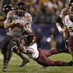 Texas Tech running back Kenny Williams, left, bust through the Arizona State defense for a 17 yard gain during the first half of the Holiday Bowl NCAA college football game, Monday, Dec. 30, 2013, in San Diego. (AP Photo/Gregory Bull)
