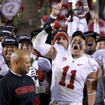 Stanford's Shayne Skov (11) celebrates along with teammates as head coach David Shaw, left, waits to get the championship trophy after the NCAA Pac-12 Championship football game against Arizona State Saturday, Dec. 7, 2013, in Tempe, Ariz. Stanford defeated Arizona State 38-14. (AP Photo/Ross D. Franklin)