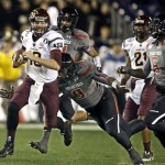 Arizona State quarterback Taylor Kelly races 51 yards with a recovered fumble as he is pursued by Texas Tech defenders during the first half of the Holiday Bowl NCAA college football game, Monday, Dec. 30, 2013, in San Diego. (AP Photo/Lenny Ignelzi)