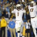 Arizona State running back Marion Grice, left, celebrates a touchdown with defensive back Lloyd Carrington during the first half an NCAA college football game against UCLA, Saturday, Nov. 23, 2013, in Pasadena, Calif. (AP Photo/Mark J. Terrill)