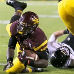 Arizona State's Marion Grice, left, dives into the end zone to score a touchdown as he breaks a tackle-attempt by Colorado's Addison Gillam during the first half of an NCAA college football game on Saturday Oct. 12, 2013, in Tempe, Ariz. (AP Photo/Ross D. Franklin)