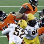 Oregon State quarterback Cody Vaz, left, fumbles the ball as he is hit by Arizona State defender Carl Bradford during the first half of their NCAA college football game in Corvallis, Ore., Saturday, Nov. 3, 2012. Oregon State recovered the fumble on their own two yard line and were forced to punt. (AP Photo/Don Ryan)