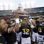 Arizona State players lift the winner's trophy after a 62-28 win over Navy during the Fight Hunger Bowl NCAA college football game in San Francisco, Saturday, Dec. 29, 2012. (AP Photo/Marcio Jose Sanchez)

