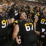 Arizona State's Jake Sheffield (91), Kody Koebensky (67) and Chris Coyle (87) celebrate a win after an NCAA college football game against Wisconsin on Saturday, Sept. 14, 2013, in Phoenix. Arizona State defeated Wisconsin 32-30. AP Photo/Ross D. Franklin)
