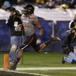 Texas Tech kick returner Reginald Davis returns a kickoff for 90 yards and a touchdown against Arizona State in the second half during the Holiday Bowl NCAA college football game Monday, Dec. 30, 2013, in San Diego. (AP Photo/Gregory Bull)