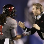 Texas tech coach Kliff Kingsbury congratulates wide receiver Bradley Marquez after his touchdown reception against Arizona State during the first half of the Holiday Bowl NCAA college football game Monday, Dec. 30, 2013, in San Diego. (AP Photo/Gregory Bull)